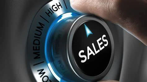 a hand pushing a button with the word sales on it