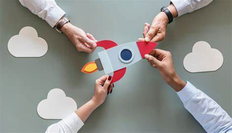 a group of people holding a paper rocket ship