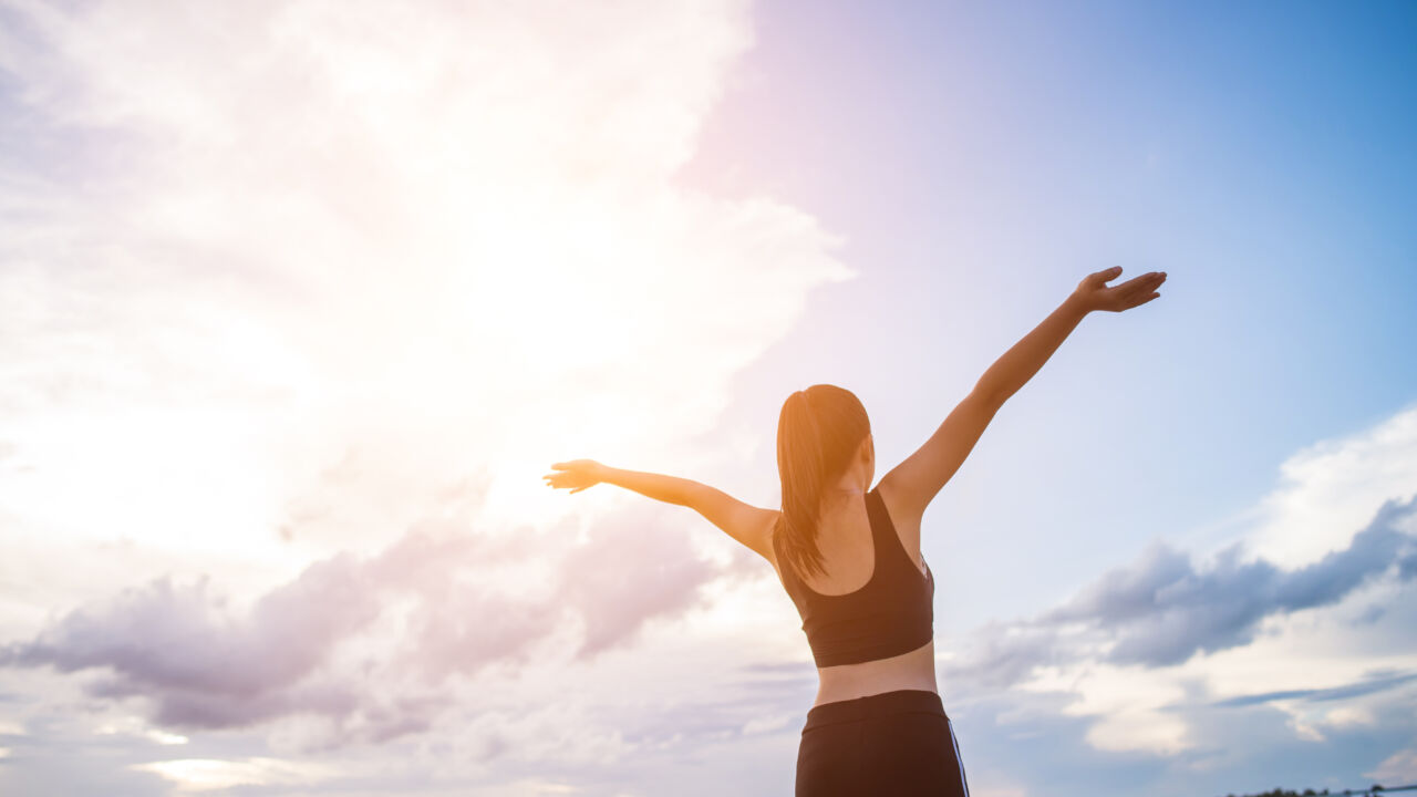 Happy Smiling Athletic Woman With Arms Outstretched Happy Smiling Athletic Woman With Arms Outstretched