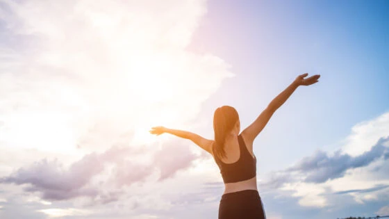 Happy Smiling Athletic Woman With Arms Outstretched