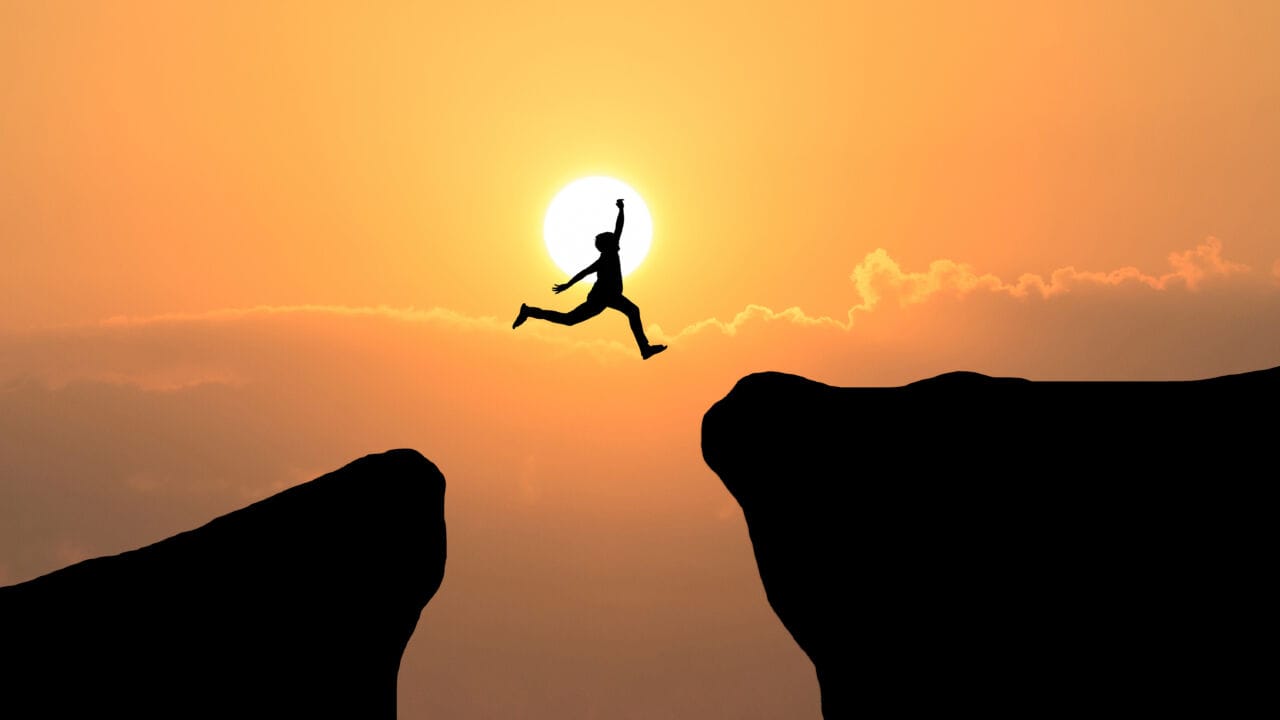Courage Man Jump Through The Gap Between Hill ,business Concept Courage Man Jump Through The Gap Between Hill ,business Concept