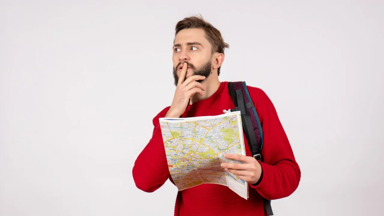 Front View Young Male Tourist With Backpack Exploring Map White Wall Plane City Vacation Emotion Human Color