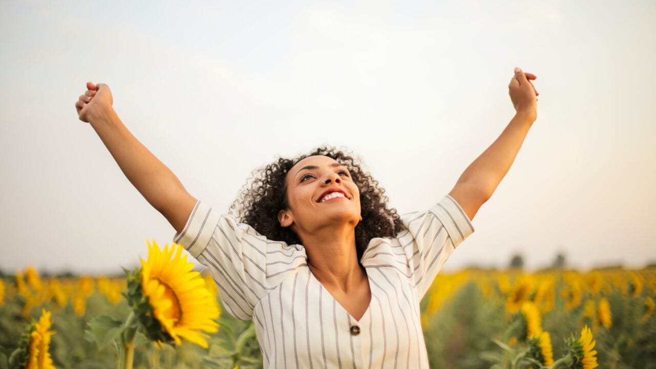 a woman standing in a field of sunflowers