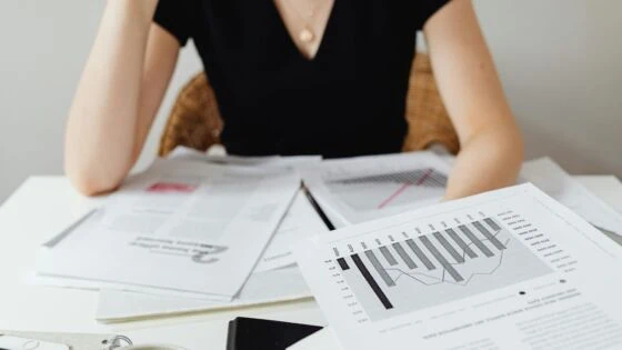 Woman analysing papers to decide her strategy